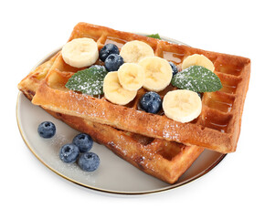 Delicious Belgian waffles with blueberries and banana on white background