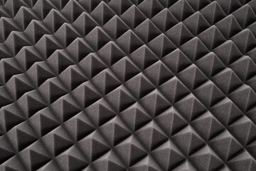 Triangular acoustic foam rubber. Sound proof texture of wall in sound studio. Background of sound absorbing sponge absorbing sponge.