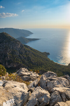 Lycian way hiking and trekking route with sea view at sunset in Turkish Mediterranean area with rocks, mountains. Mountain landscape image taken on the Lycian way trek in Turkey	
