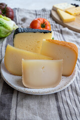 Cheese collection, French fol epi  cheese with many little holes, etorki, tomme noire des pyrenees and ossau iraty cheese