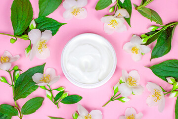 Top view of white plastic cosmetic container for moisturizing cream as a mock up with bright fresh...