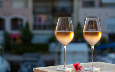 Tasting of local rose wine in summer with sail boats haven of Port Grimaud on background, Provence, France