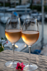 Tasting of local rose wine in summer with sail boats haven of Port Grimaud on background, Provence, France