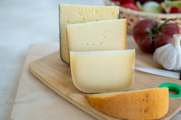 Cheese collection, French fol epi  cheese with many little holes, etorki, tomme noire des pyrenees and ossau iraty cheese