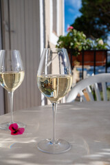 Tasting of local white wine on sunny summer balcony Provence, France
