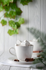Mug with hot chocolate and marshmallows on wooden table