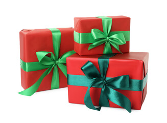 Red gift boxes with green bows on white background