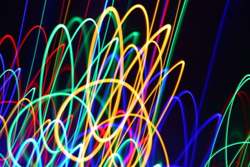 Multicolored lines on a black background patterns graphic on a long exposure