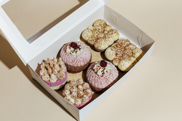 closeup various handmade vegan chocolate cakes in the gift box on yellow background