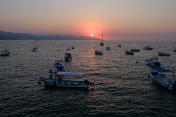 Naklejka premium Puerta Vayarta sunset and fishing boats Mexico.