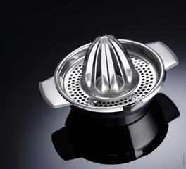 Manual fruit juice squeezer on shiny table