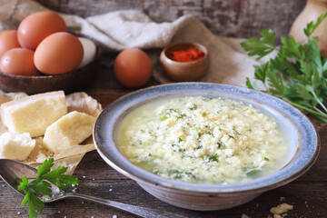 Italian cuisine. Stracciatella soup: parsley, eggs and parmesan cheese