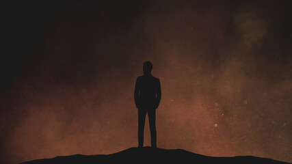 The human silhouette standing on a night cloudy background