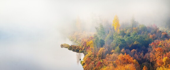 Breathtaking panoramic aerial view of the colorful red, orange and yellow trees of a mixed...