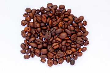 A group of roasted coffee beans, fresh brown in color, ready to be grinded and made drinks, the theme is freshness and relax