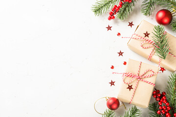 Christmas composition with present box, fir tree and decorations. Greeting card with space for text.