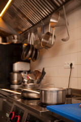 Vertical shot of a boiling pot on the stove at the restaurant