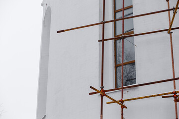 Scaffolding on the building. Building renovation.