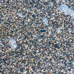 sea beach of small multi-colored pebbles as a natural background