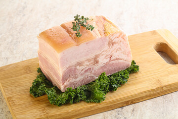 Cut of pork bacon over board