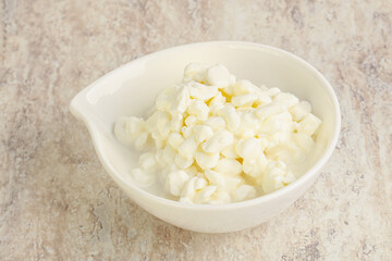 Grained cottage cheese in the bowl