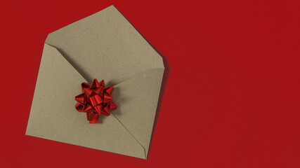 Open blank kraft paper envelope on red background.