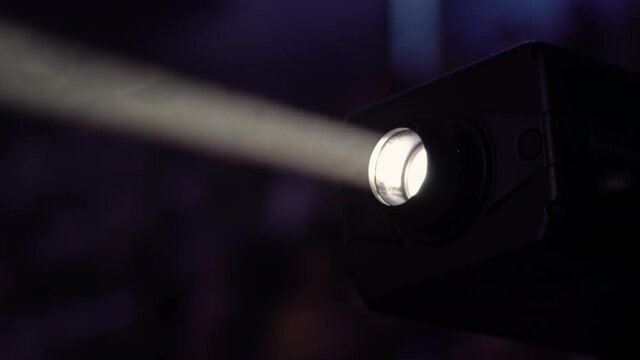 Wide lens projector with light beam for movie and cinema at night