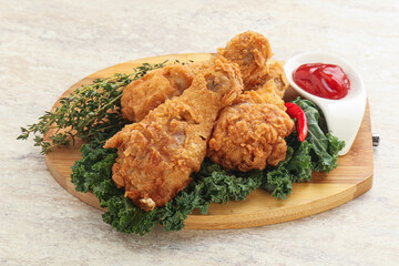 Fried chicken drumsticks with tomato sauce