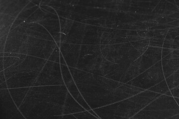 Texture of scratched black surface as background, closeup