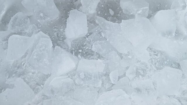 Super slow motion of falling crashed ice into white background. Filmed on high speed cinema camera, 1000 fps. 