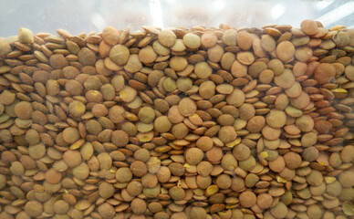 Green lentils. Grains background. In the store on the showcase.