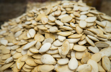 Mountains of pumpkin seeds. Healthy diet. On the counter of the store.