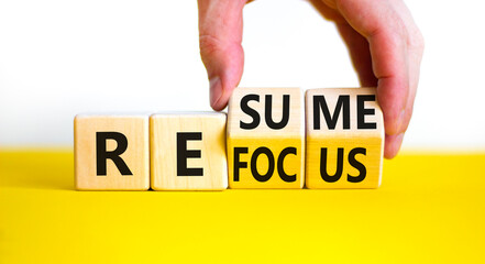 Refocus and resume symbol. Businessman turns cubes and changes the word 'refocus' to 'resume'....
