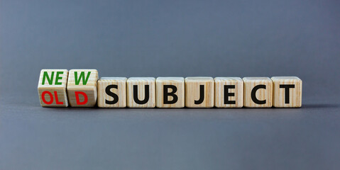 Old or new subject symbol. Turned wooden cubes and changed the word old subject to new subject. Beautiful grey table, grey background. Business, old or new subject concept. Copy space.