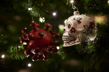 ornaments of a virus and a skull as symbol of impact of covid-19 on xmas season