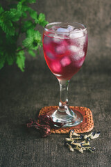 red tea with blue ice cube