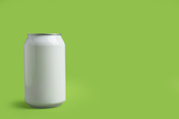 White can of energy drink on green background. Space for text