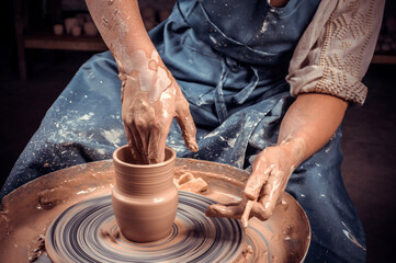 Craftsman master making ceramic pot on the pottery wheel . Concept for woman in freelance, business, hobby. Close-up.