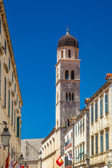 Fototapeta na wymiar Tower of Franciscan Church and Monastery on Stradun street in the historic city center of Dubrovnik in Croatia, Europe.