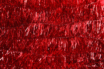 Bright red tinsel as background. Festive decoration