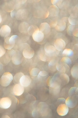 bright glitter background: bokeh effect from many colored lights on frozen glass, toning