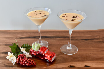 Fancy holiday eggnog and coffee martini drinks ready to serve at home or party, restaurant at Christmas season event. 