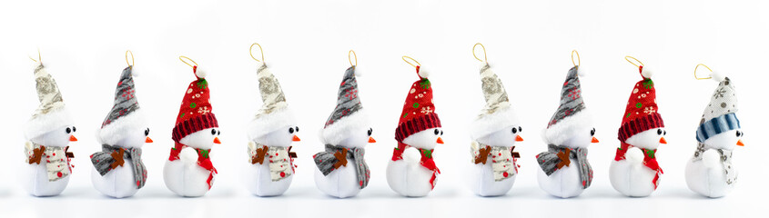 Snowman in the snow. New Year Merry Christmas. Red hat. On white background. Lots of snowmen. Christmas decorations. Santa.