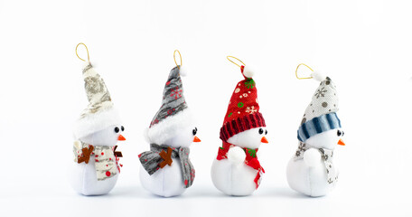 Snowman in the snow. New Year Merry Christmas. Red hat. On white background. Lots of snowmen. Christmas decorations. Santa.