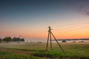 Dawn with fog in the field. Ukraine..