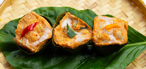 Thai streamed fish curry in banana leaves