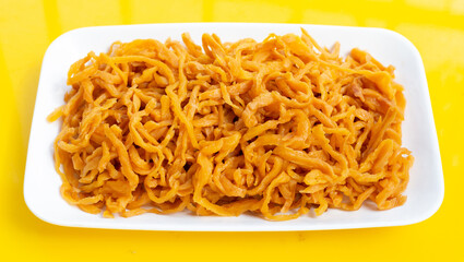 Pickle Turnip in white plate on yellow background.