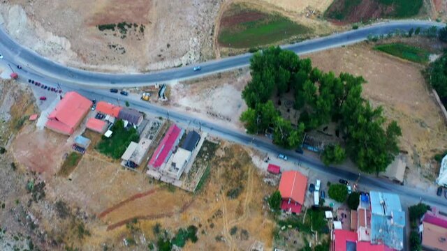 Aerial Forward Beautiful Shot Of Built Structures On Mountain, Cars Moving On Road - Bsharri, Lebanon