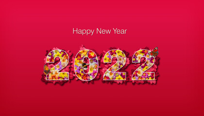 Fototapeta na wymiar Bonne année 2022 - Lettres remplies de fleurs multicolores, entourées de fleurs détourées sur fond rouge