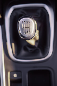 Six speed manual gear box top down view, selective focus. Framed by metallic decorative frame.